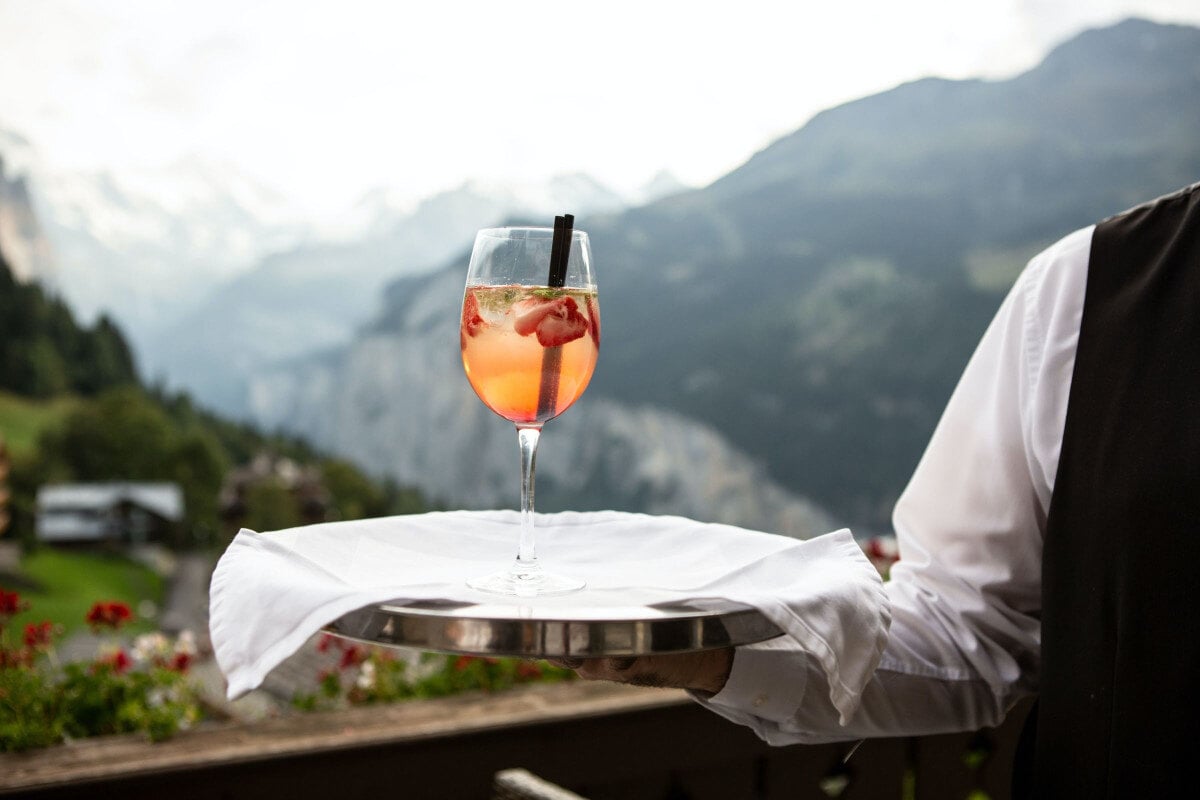 catering waiter serving alcoholic beverage