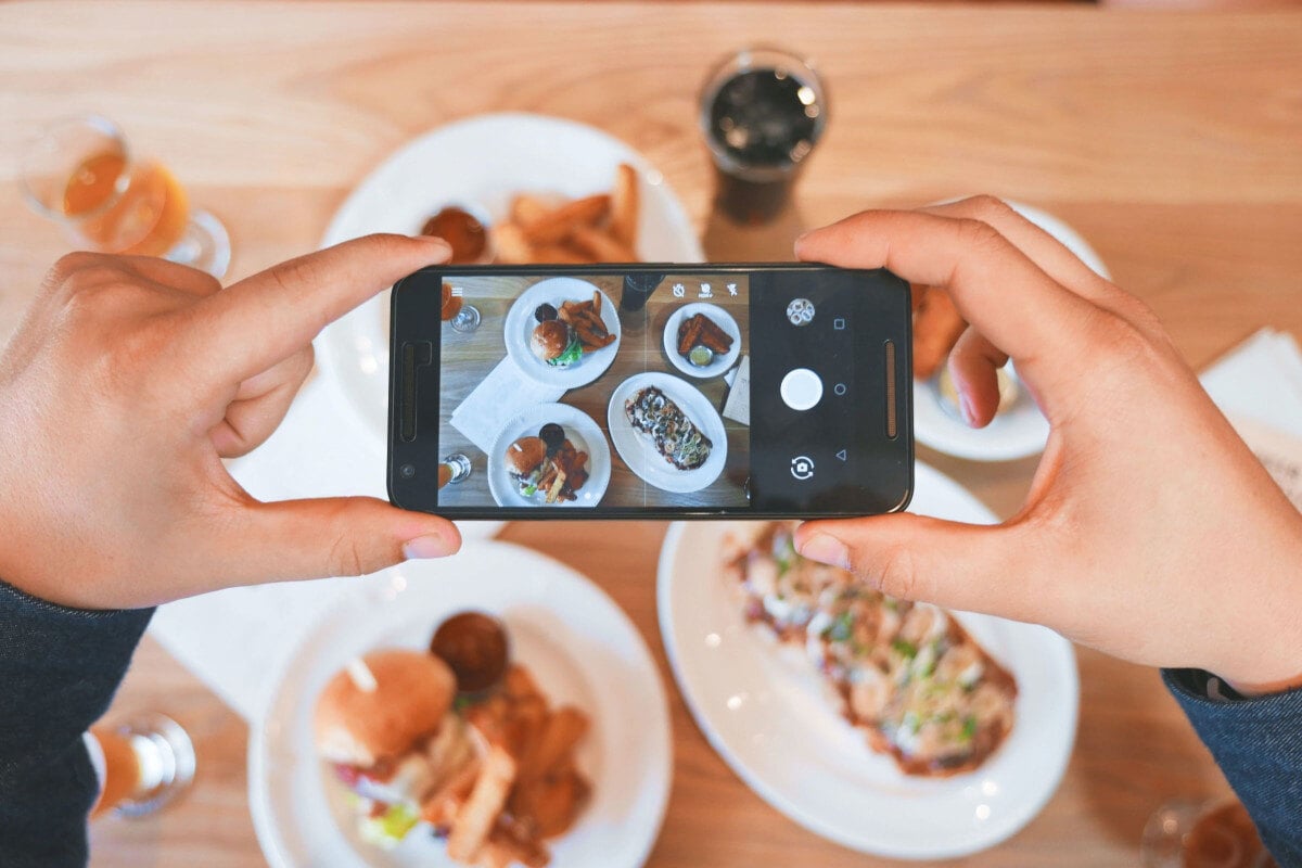 restaurant owner taking marketing image of their dish